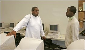 Charlottesville High School student Brandon Thompkins, left, speaks with Dustin Saunders, who is working at the school as part of the National College Counseling Corps.