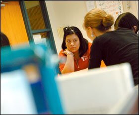 Itzel Alcantar, facing forward, listens to her teacher during an ESL class, part of her schedule of activities provided through the migrant education program at Kennett Middle School in Landenburg, Pa.