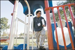 Checking for loose screws on playground equipment.