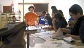 University of Texas graduate student Frank Serpa guides middle schoolers from Citizen Schools in Austin through the newspaper-production process.