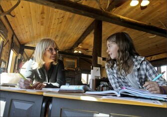 Corinne works with her teacher, Linda Geary, during class at Notch Peak Elementary. The school is housed in a horse barn two miles from Gaby’s home–Geary lives nearby in a trailer on the ranch’s property.
