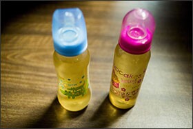 Bottles of water filled by Flint, Mich., residents sit on the table outside of city council chambers as Michigan Gov. Rick Snyder speaks during a news conference last week. Snyder pledged that officials would make contact with every household in Flint to check whether residents have bottled water and a filter and want to be tested for lead exposure while his embattled administration works on a long-term solution to the city's water crisis.