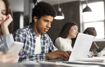 Student doing homework in college library