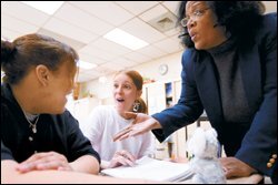 Jewell Dent, right, teaches from the Kaplan curriculum during an English 1 class at Bartram Academy of Business and Finance.