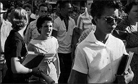 Central High School students, including Hazel Bryan, left, shout insults at Elizabeth Eckford as she marches down to a line of National Guardsmen, who blocked the main entrance and would not let her enter school in Little Rock on Sept. 4, 1957.