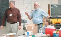 Math teacher Paul Nickels, left, and Bruce Nichols, right, the lab-occupations instructor, team-teach at Van Buren Technology Center. Mr. Nickels brings an academic component to students' practical lab work.