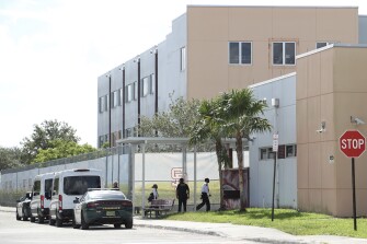 Court deputies exit vans that transported jurors to Marjory Stoneman Douglas High School in Parkland, Fla. on Aug. 4, 2022, to view the "1200 building," the crime scene where the 2018 shootings took place. This during the penalty phase in the trial of confessed shooter Nikolas Cruz who previously plead guilty to all 17 counts of premeditated murder and 17 counts of attempted murder. Cruz waived his right to be present at the viewing.