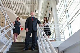 Superintendent David B. Smith, head of the Evansville Vanderburgh district in Indiana, stands with Carrie Hillyard, left, the district’s chief transformation officer, and Kelsey Wright, director of school transformation.