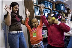 Ms. Mahese encourages 5-year-olds Devin Hughley, center, and Kyara Lezama, right, to imagine what it’s like to be a tree during their field trip to the botanical gardens.
