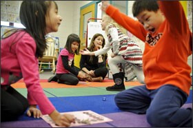 Children in Amy Raymond's kindergarten class at Triadelphia Ridge Elementary School in Glenelg, Md.—from left, Marisa Lamb, Sierra Collis, Caroline Zdrale, and Dylan Ma—play a number game that incorporates content from the common-core standards for mathematics. Preschool educators in several states are taking steps to align their curricula to the new common standards.
