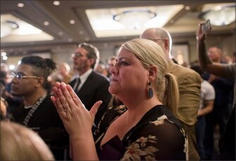 Teacher Kate Walliser, 33, of Phoenix, Ariz., reacts during gubernatorial candidate David Garcia's concession speech at the Arizona Democrats election watch party in Phoenix, Ariz.
