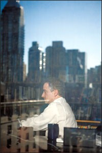 David M. Steiner sits in his office at Hunter College, with New York City reflected in the background. The dean of the education school and his colleagues collaborated with three charter groups to set up a teacher-training program.