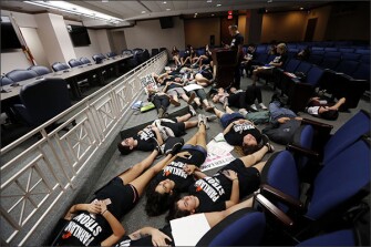 Seventeen student survivors from Marjory Stoneman Douglas High School lie down on the floor in silence and pray at the approximate time of the attack one week ago, inside the state capitol, in Tallahassee, Fla., on Feb. 21. The students, members of the Congregation Kol Tikvah Temple, lost three students, and were at the capitol to pressure lawmakers on gun control reform.