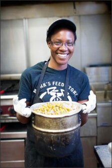 Brihanna Thompson, 22, holds a pot of green beans in the kitchen of Mark’s Feed Store in Louisville, Ky., a restaurant where she first was hired through a city summer jobs program. This summer, city officials plan to place nearly 2,500 youths in jobs, either at private companies or through local government agencies.