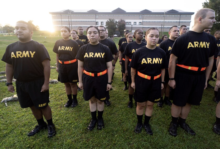 Students in the new Army prep course stand at attention after physical training exercises at Fort Jackson in Columbia, S.C., on Aug. 27, 2022. The new program prepares recruits for the demands of basic training.