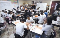 Sharon Ponder, a nationally certified teacher, leads her 8th graders in a poetry lesson last week. Students in the upper grades at Sherman School in Chicago are crowded into classrooms in a building that was supposed to be demolished some seven years ago.