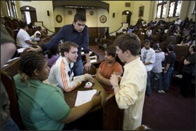 Andrew Hobaugh, right, talks with John Connor, in white jacket, and other team members from Chicago schools while waiting to learn the tournament winners.