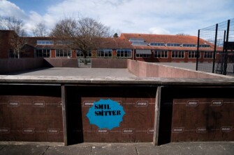 A sticker reading “Smiling is contagious” is seen at the playground at Stengaard School in Gladsaxe, Denmark.
