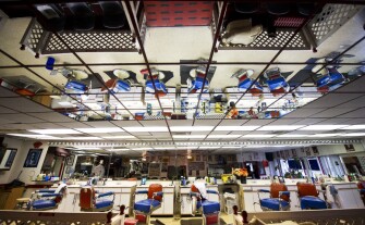 Overhead mirrors reflect the space inside Willy Tee’s barbershop.