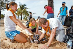 American students from an international school in Phuket, Thailand, help with a cleanup effort along Patong Beach in southern Thailand this month. In the United States, schools are helping to raise money for disaster relief.