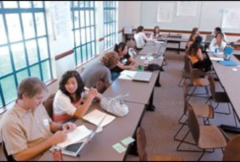 Mills College education student Chris Scheer, left, discusses teaching with high school student Kayla Nine-Expinosa.