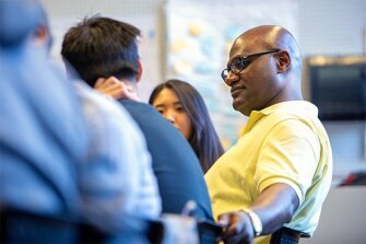 Vance Baker, a secondary teacher-candidate at the University of Washington, listens during the people of color caucus.