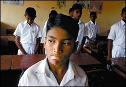 A group of students in Panadura, Sri Lanka, holds a moment of silence last week to honor fellow students and teachers who died when the Dec. 26 tsunami hit their town. It was the students' first day back to classes since the disaster. Many children in the hard-hit parts of South Asia have returned to school, some in tents pitched near their destroyed school buildings.