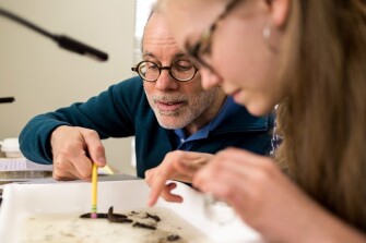 Ann Arbor, Mich., resident Brian Carlson, 56, and his daughter Sophie, 16, inspect bugs in their water sample. They have been participating in the event together for the past four years. “It allows you to connect,” said Brian Carlson.