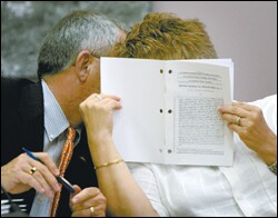 Rep. Kathie Decker, the chairwoman of the House education committee, confers behind a school finance bill with Rep. Michael O'Neal during the special session.