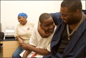 Benjamin Boisseau, 15, center, plays with his brother, Kevin. His mother, Kathy, left, would like to transfer him out of McDonogh.
