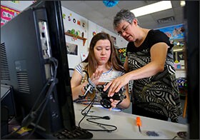 Tammy Glass, right, works with her daughter Kristie Glass as she builds a robot that can be used as a hands-on application for code writing. The robot was purchased with state grant money that also enabled Tammy Glass to attend a boot camp on teaching computer coding.