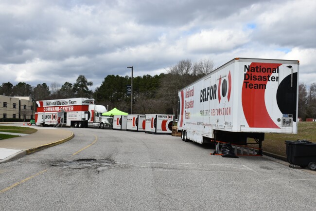Trucks from a property restoration company were parked outside the Grafton complex in February of 2020, providing supplies for the cleanup.
