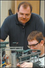Mark Thomas, a former auto mechanic, now teaches at Soddy-Daisy High School's engineering academy, whose 120 students learn in a high-tech environment.