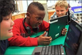From left, 5th graders Tiffany Phongsy, Jabari Doman, and Fed Beloborodov wait for a video to display during Golriz Karoubi's class at E.J. Sand Public School in Thornhill, Ontario.