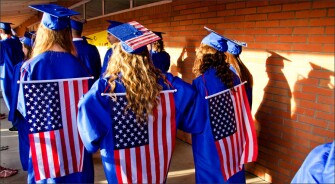 Chloe Wright, from left, Ari Parker and Elissa Ropp, line up to walk down the aisle at Walla Walla (Wash.) High School’s graduation.