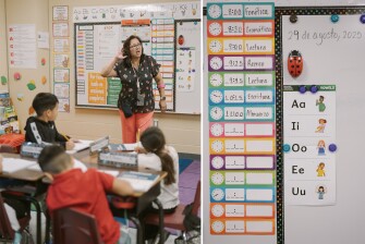 Left: Diana Oviedo-Holguin teaches a first grade English learner class at Heritage Elementary School in San Antonio, Texas, on Sept. 3, 2025. Right: English and Spanish materials are seen on her walls.