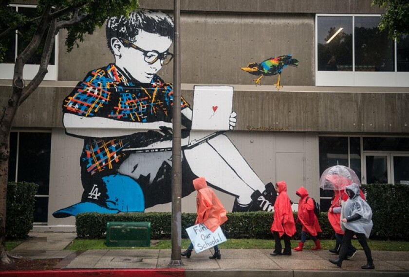 Thousands of teachers rallied through downtown Los Angeles to demand higher pay, more support staff, and smaller classes.