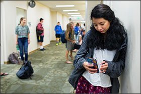 Sabrina Villanueva waits for her Spanish class to start at the University of Rochester. She said she had to rethink her plans to minor in psychology or sociology while majoring in engineering when her dual-enrollment credits failed to transfer.