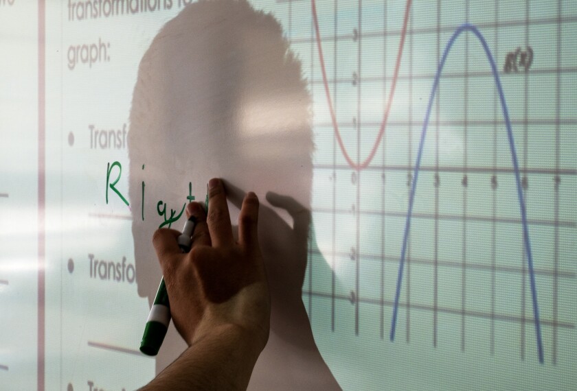 Tenth grader Thinh Vuong Phung works on a math problem at Annandale (Va.) High School on April 8, 2026. The class reflects the school’s approach of combining group work, language supports, and progress monitoring to help multilingual learners build confidence and mastery in math.