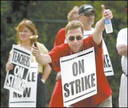 Ohio: Brian Loges, an art teacher at Wayne High School in Huber Heights, pickets outside the school Aug 25.