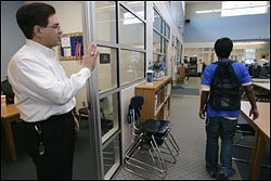 Robert J. LeBlanc, an engineer who volunteers as a mentor through Communities in Schools of San Antonio, waves goodbye on Dec. 7 to 10th grader Chris Osorio after their weekly meeting at John Jay High School.