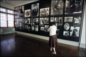 Mary Sinha, an educator at Saint Augustine of Canterbury School in Kendall Park, New Jersey, examines photos of immigrants who came through Ellis Island.