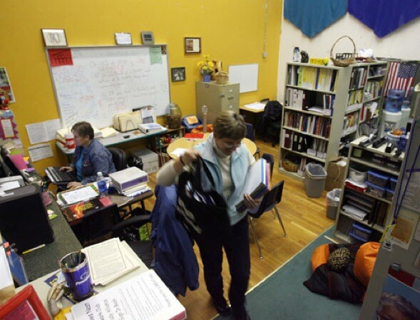Special education assistant Julie Blaugher and teacher Lisa Cates, seated, have office space in a converted raquetball court that also serves as a library, meeting room, and classroom. Many charter operators have had to show resourcefulness in finding a place to educate students, whether it's a former Kmart, car dealership, a church facility, or space in an office complex.