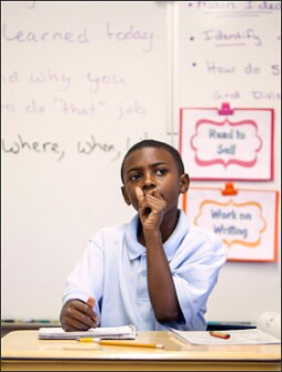Zaz Robinson, a student in Yolanda Medrano’s 4th grade class at Emerson Elementary School in Albuquerque, N.M., ponders the “who, what, where, when and why” of the career fair he attended with his classmates. Ms. Medrano assigned the class a journaling exercise following the fair to bring the activity within the common-core approach the school has adopted.