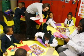 Ms. Haskell helps a mixed class of prekindergarten and kindergarten students with a Valentine’s Day project at Scott Montgomery Elementary School.