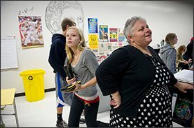 Severna Park High School freshman Hannah White, puts away her laptop at the end of her algebra class as her teacher, Mary Brierley, talks to students. Ms. Brierly says the Cognitive Tutor math program used in her class encourages students to take the initiative to work through problems.