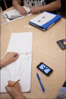 Joe Stacey, a freshman at Oak Hills High School in suburban Cincinnati, uses his iPod touch to find a flower on the Internet to draw for an art class.