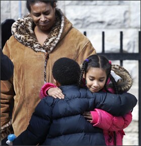 CHICAGO: Maria Llanos, left, watches her daughter, Xochilt Fernandez, hug a classmate at Lafayette School at the end of the day. Lafayette is on the list of schools the district plans to close as part of a cost-cutting effort opponents say will disproportionately affect minority children.