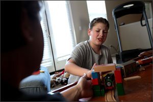 Paul Driscoll builds a bridge out of blocks during a home-therapy session in San Diego. When the military family moved to the area, they had to engage the service of U.S. Marine Corps lawyers to persuade their new school district to provide the same level of special education services that Paul had been getting in his previous district.