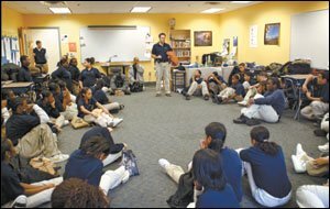The school's director, Matthew Taylor, holds a disciplinary session with students. The kids wear uniforms and must adhere to a strict behavioral code.